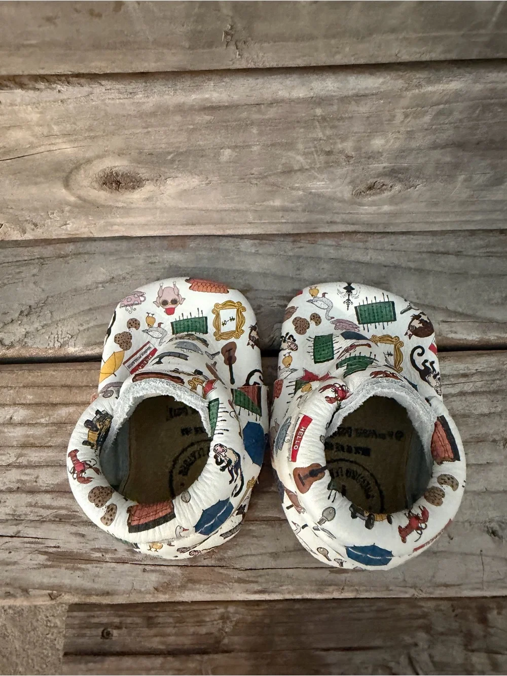 Freshly Picked “Friends” White Baby Moccasins with Multicolor Home Icons